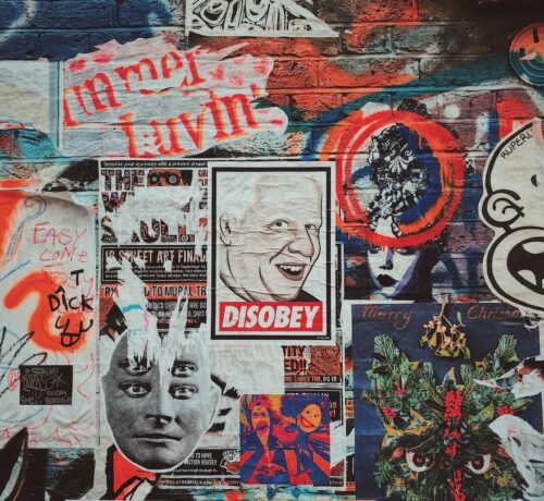 Posters and street art on a facade on Brick Lane in east London