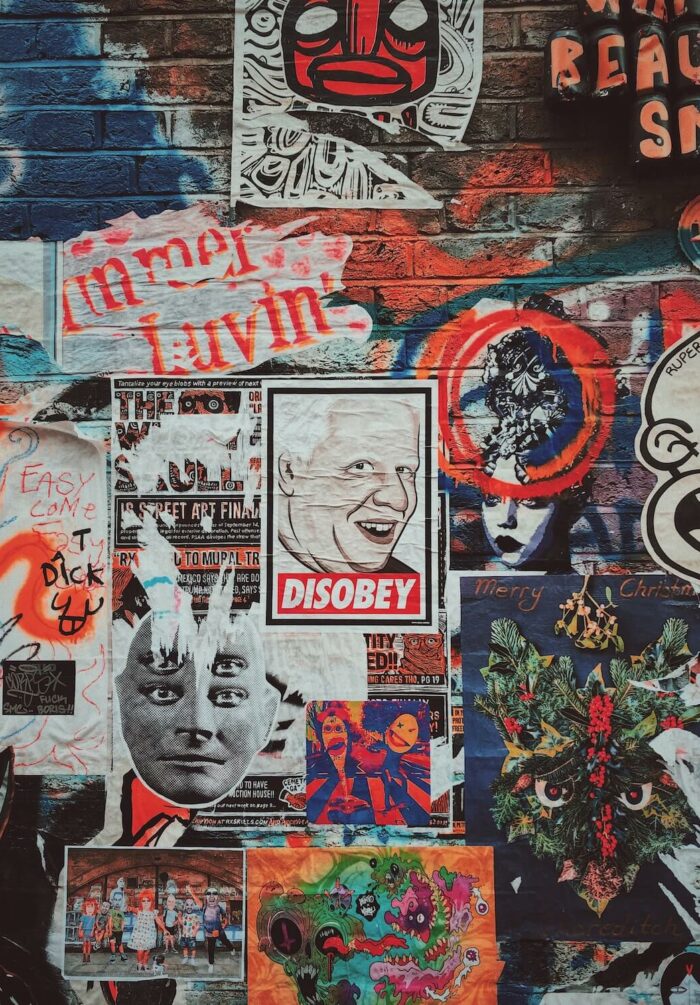 Posters and street art on a facade on Brick Lane in east London